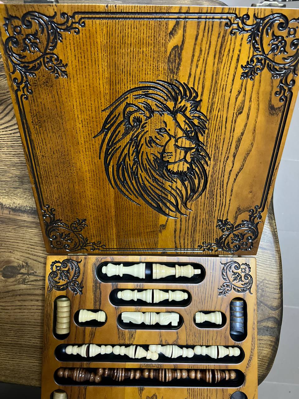 Open wooden chess and checkers set made of ash wood with lion design, organized compartments for chess pieces and checkers