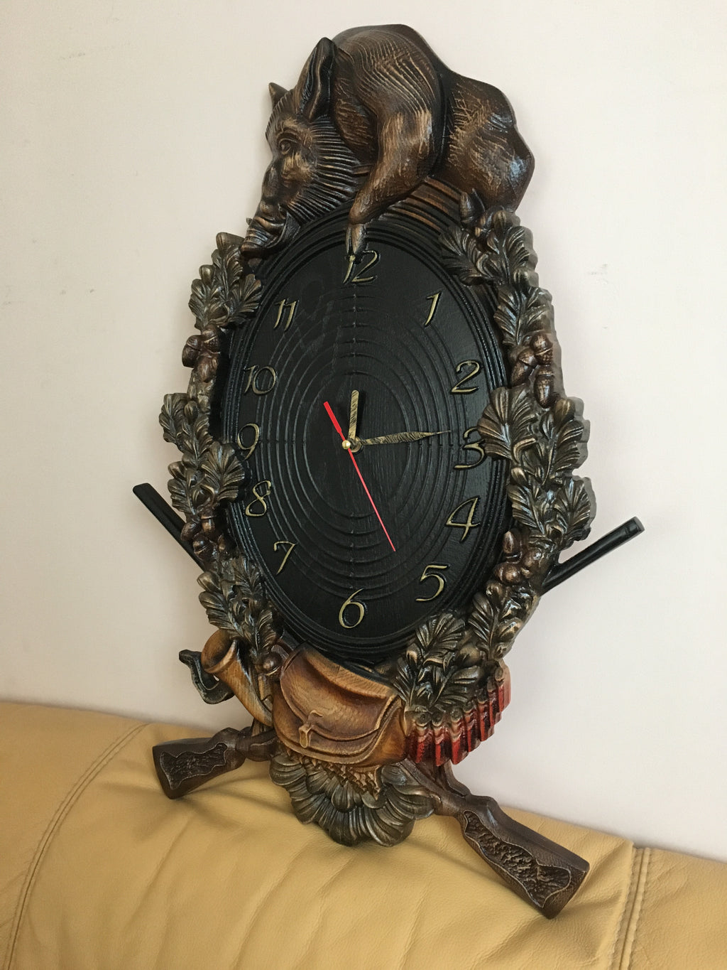 Wooden wall clock with wild boar carving shown at angle, handmade hunting home decor