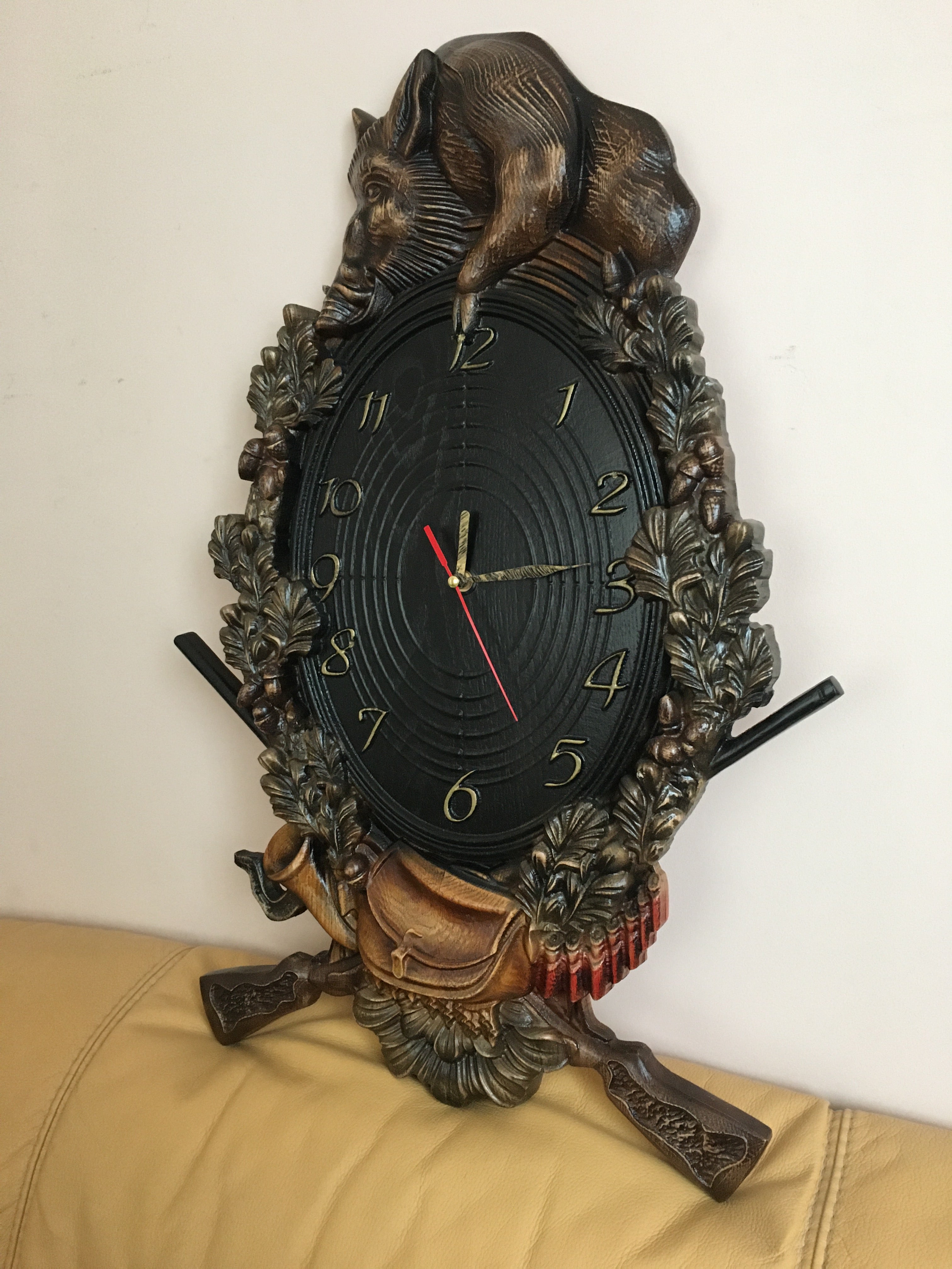 Wooden wall clock with wild boar carving shown at angle, handmade hunting home decor