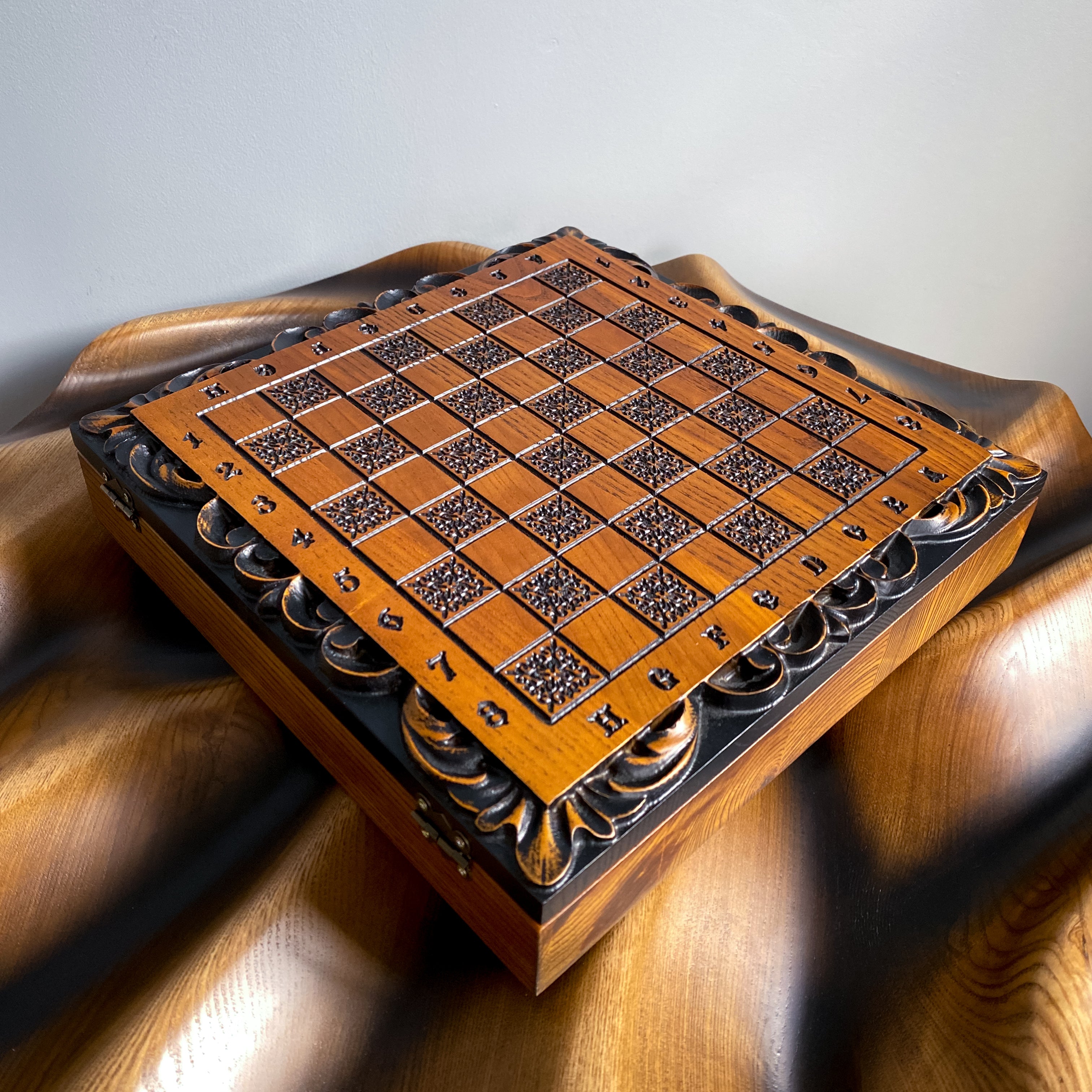 Wooden chess and checkers board with carved ornaments and bear symbol