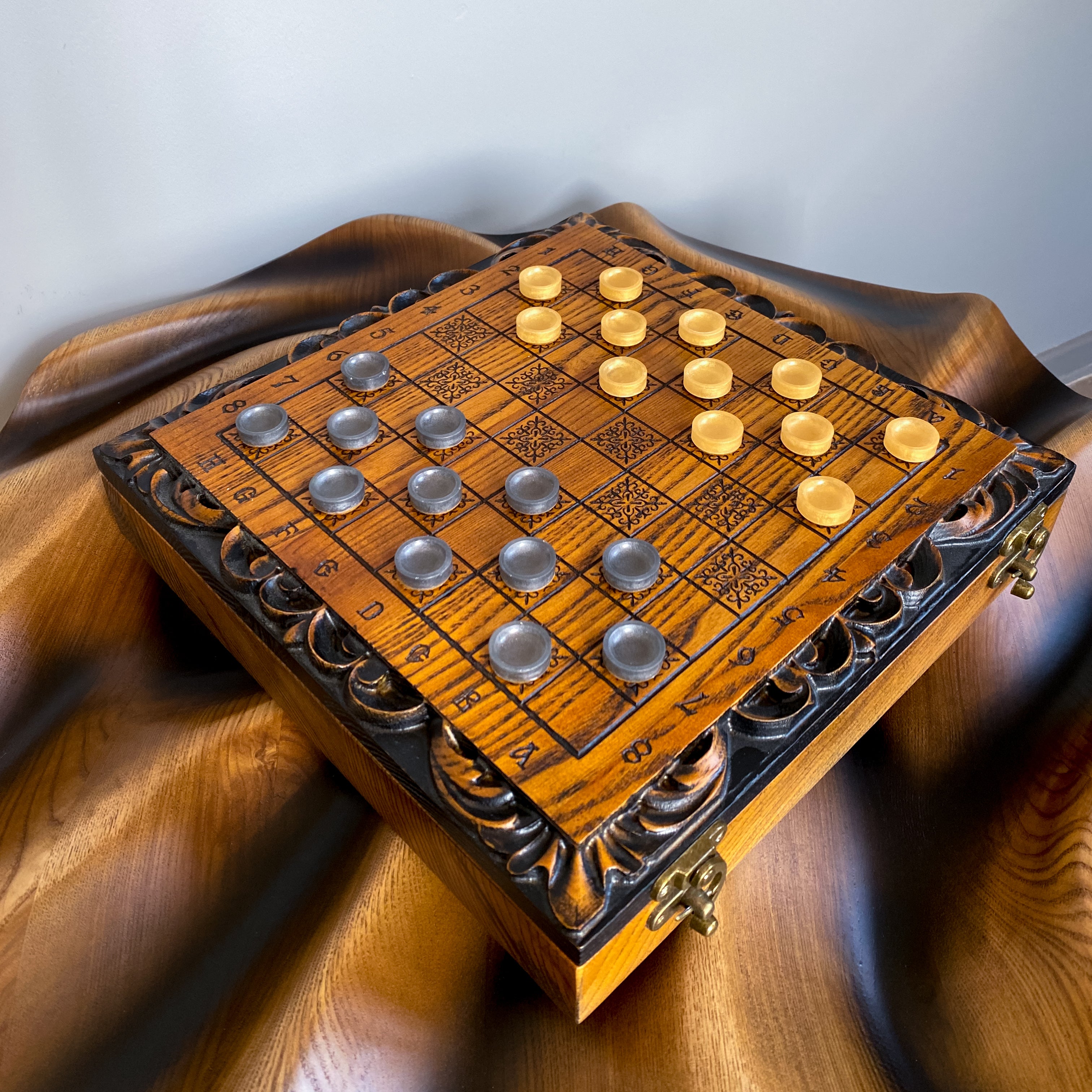 Wooden checkers game on carved ash wood board, artisan craftsmanship