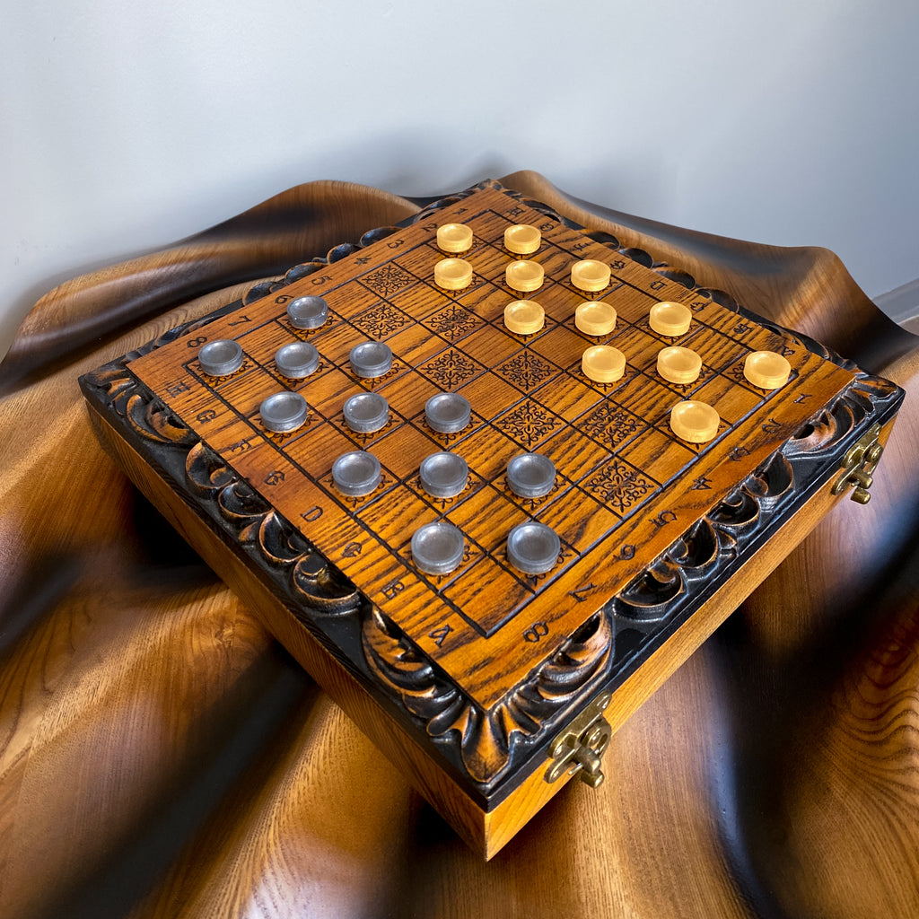 Open wooden chess and checkers box showing carved ash wood interior