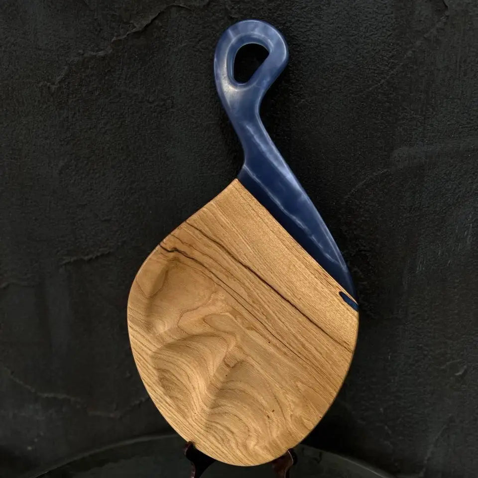 Close-up of natural wood grain on a handmade epoxy resin cheese board