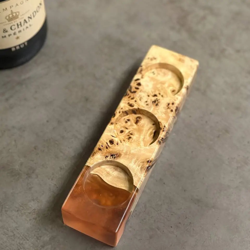 Handmade wooden candlesticks on a dining table with champagne