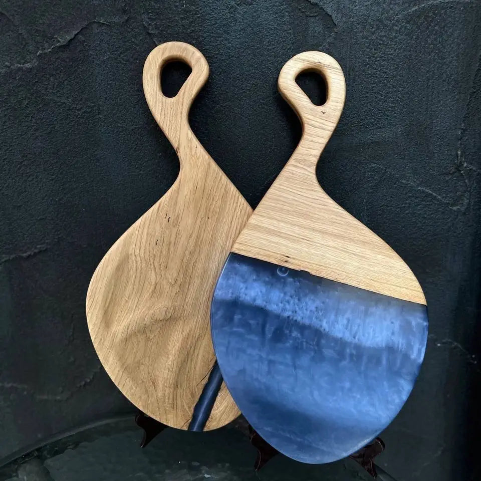 Handmade wooden cutting board set with blue epoxy resin and natural wood grain