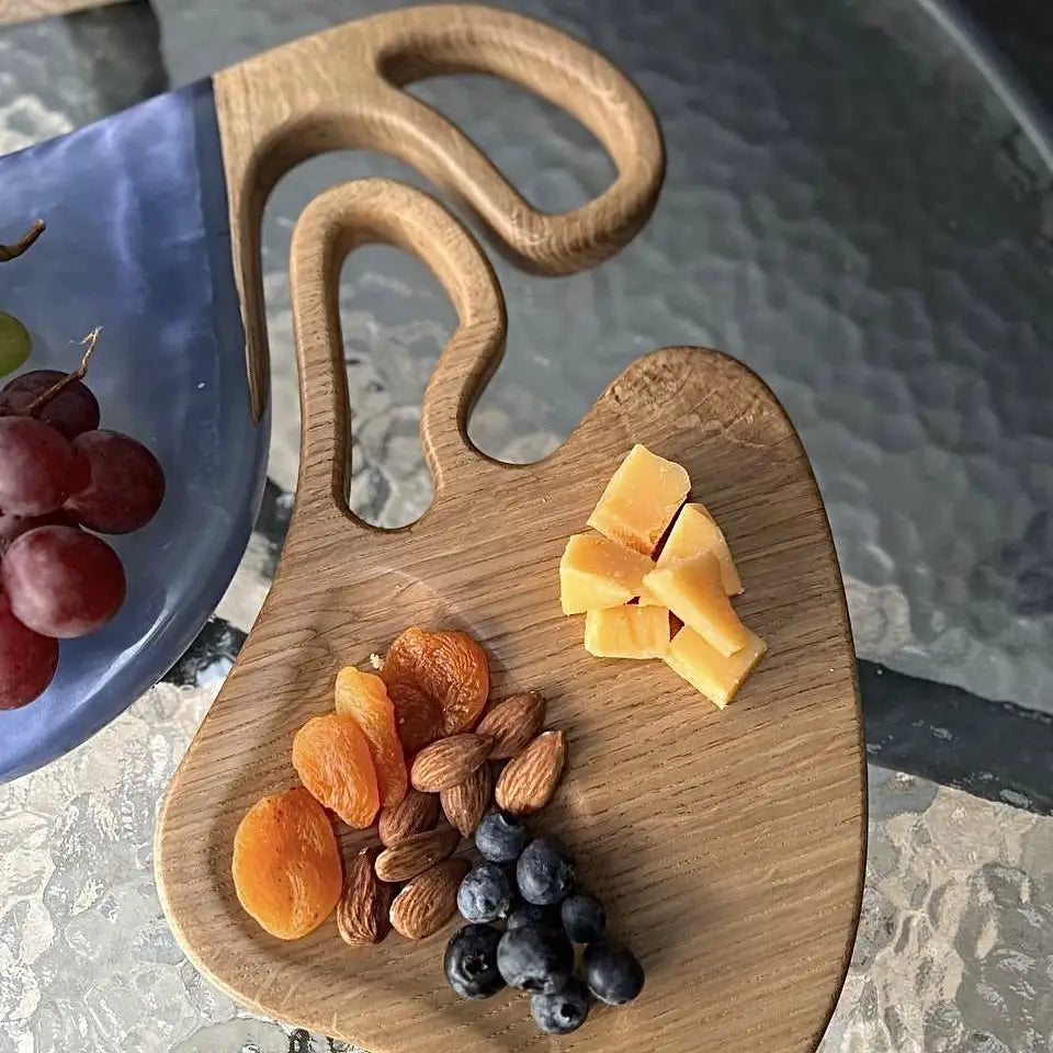Handmade charcuterie boards with decorative blue epoxy resin handles