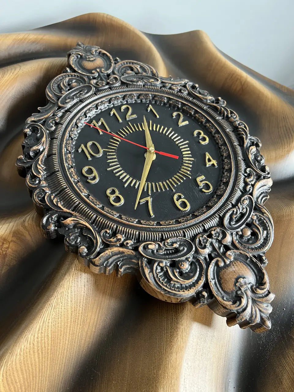Handcrafted oval ash wood wall clock with artistic carving and classic black dial