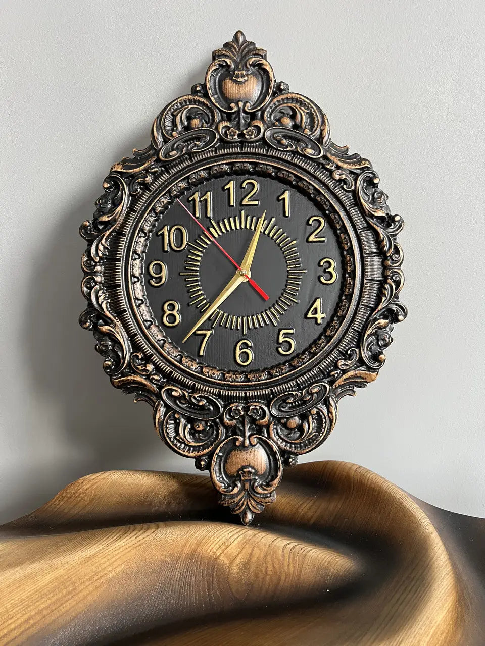 Oval wooden wall clock made of solid ash wood with decorative carved frame