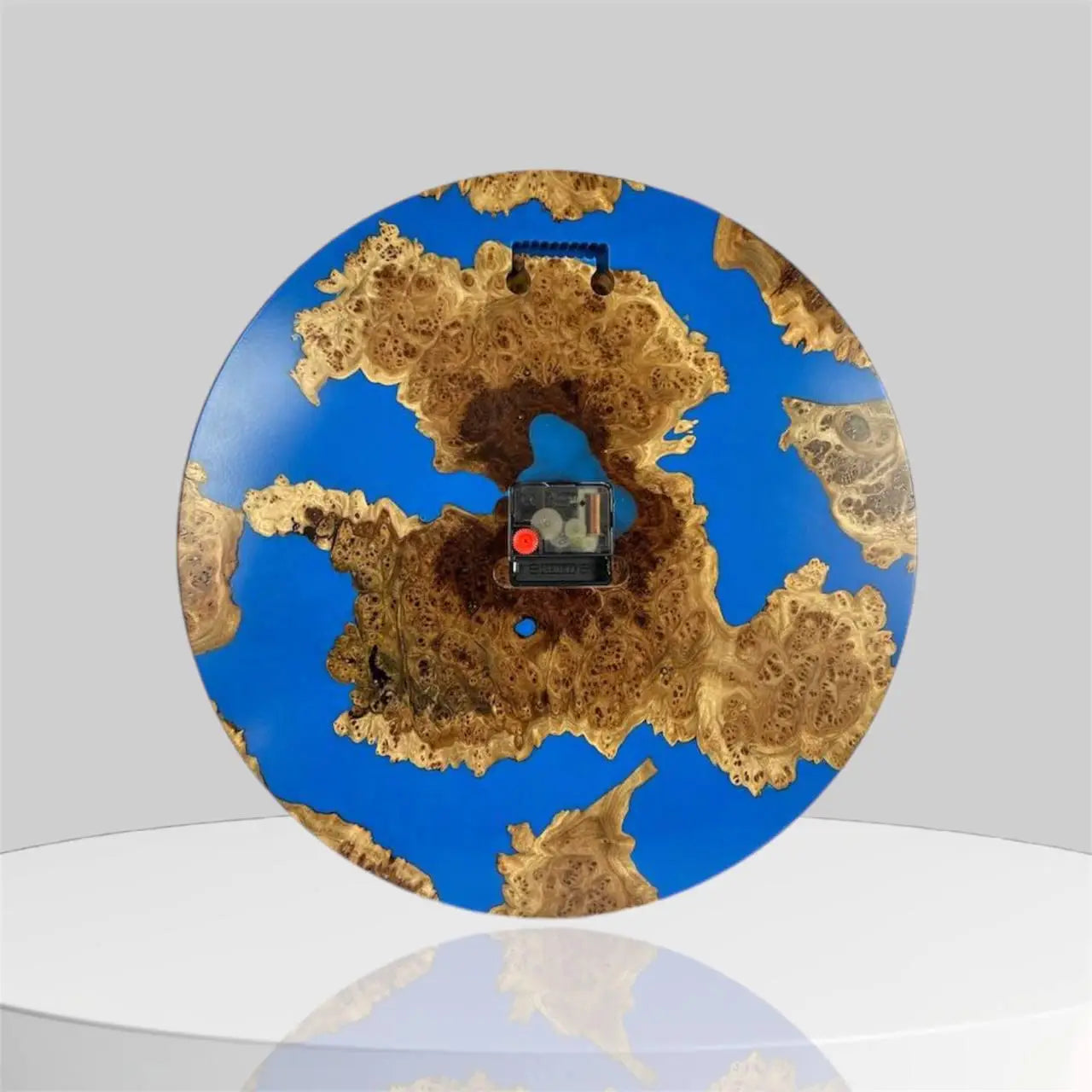 Burl wood wall clock crafted with vibrant blue resin