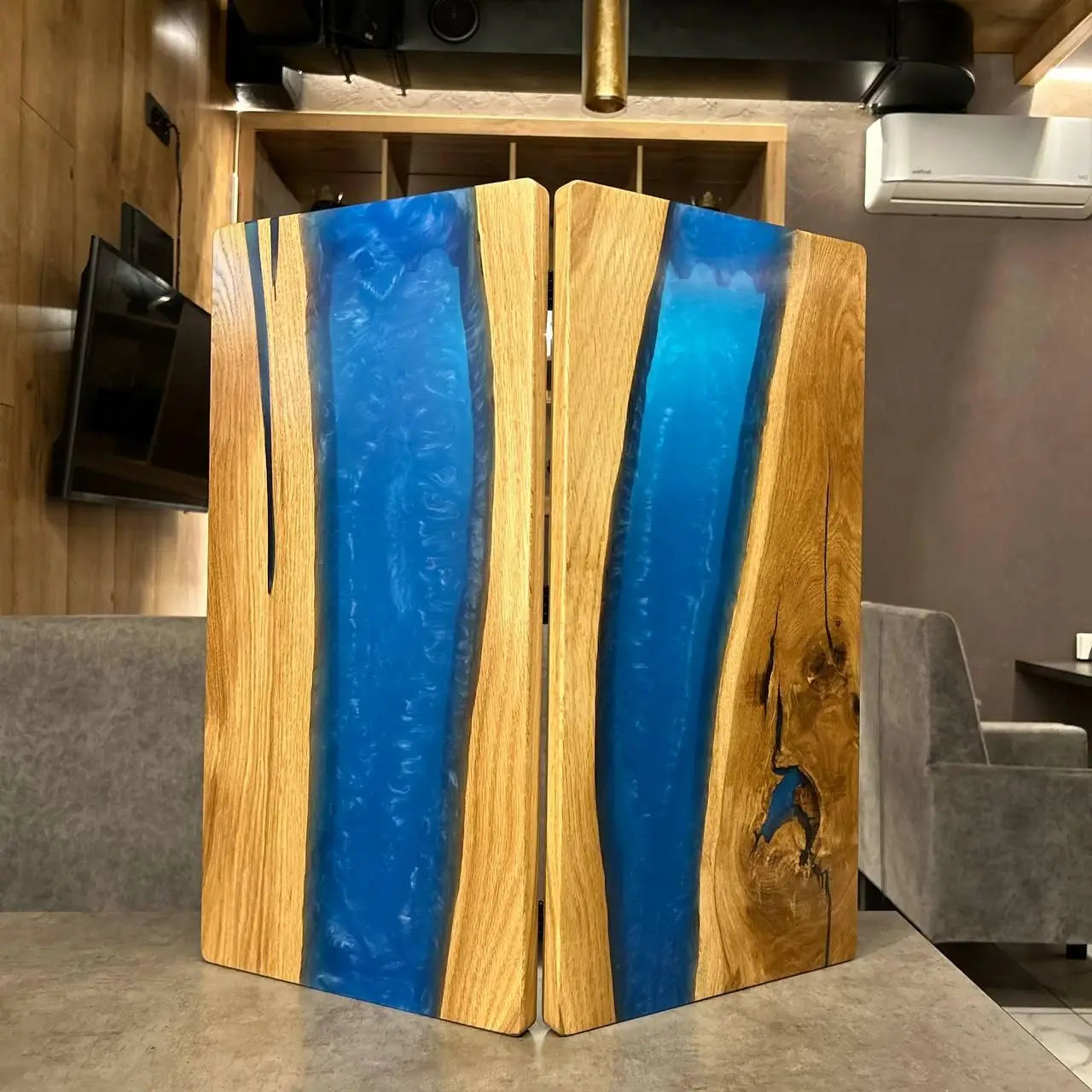 Closed wooden backgammon set with flowing blue epoxy resin design