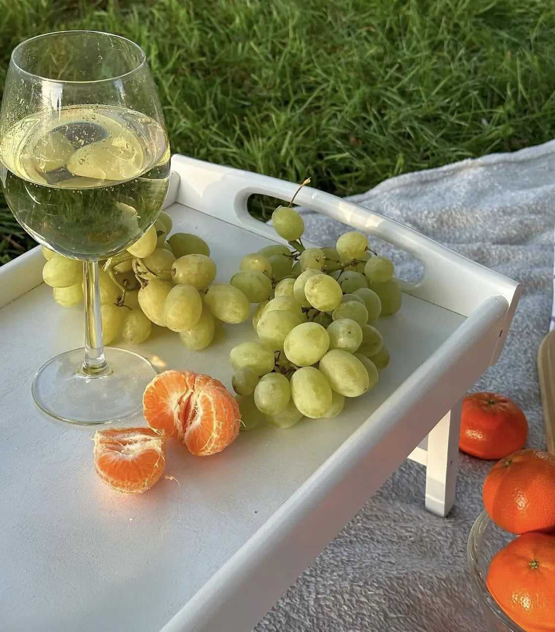 Breakfast in bed tray with wine glasses and fruits