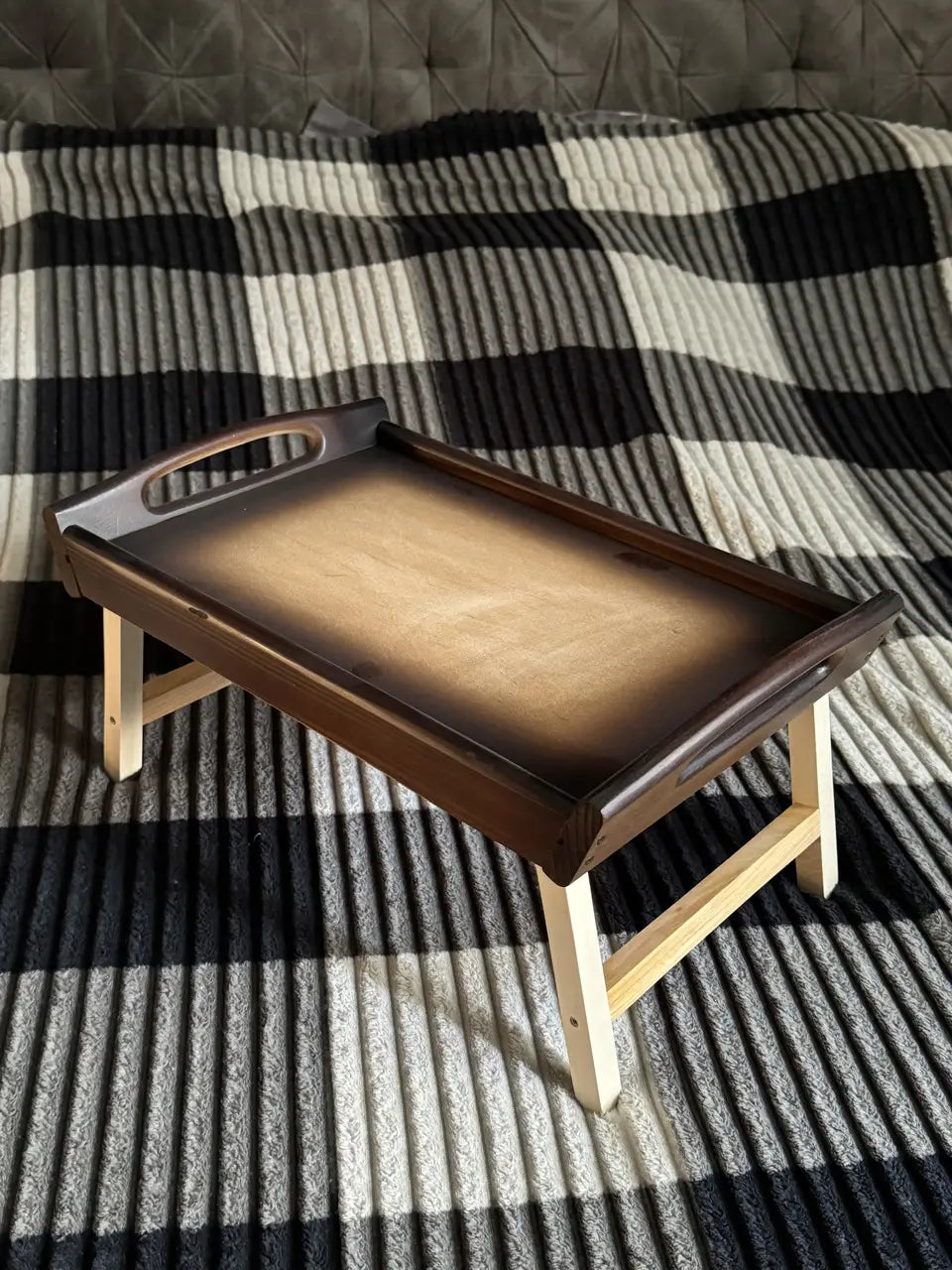 Retro wooden breakfast bed tray on bed with folded legs
