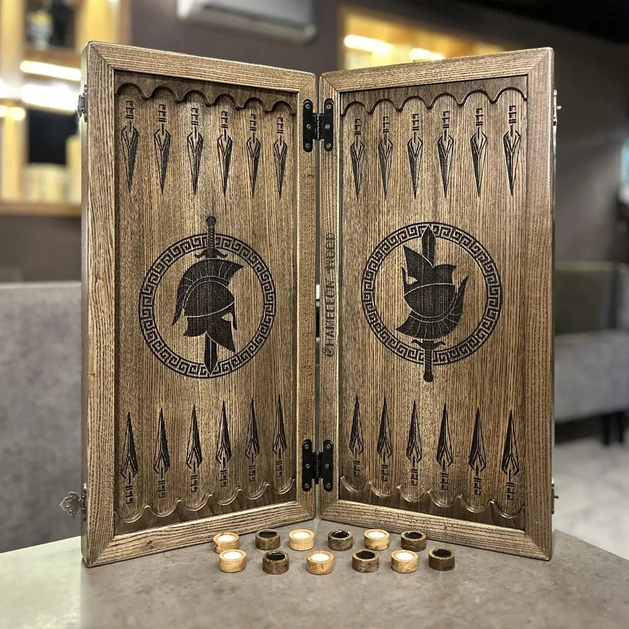 Close-up of hand-painted Spartan artwork on wooden backgammon board