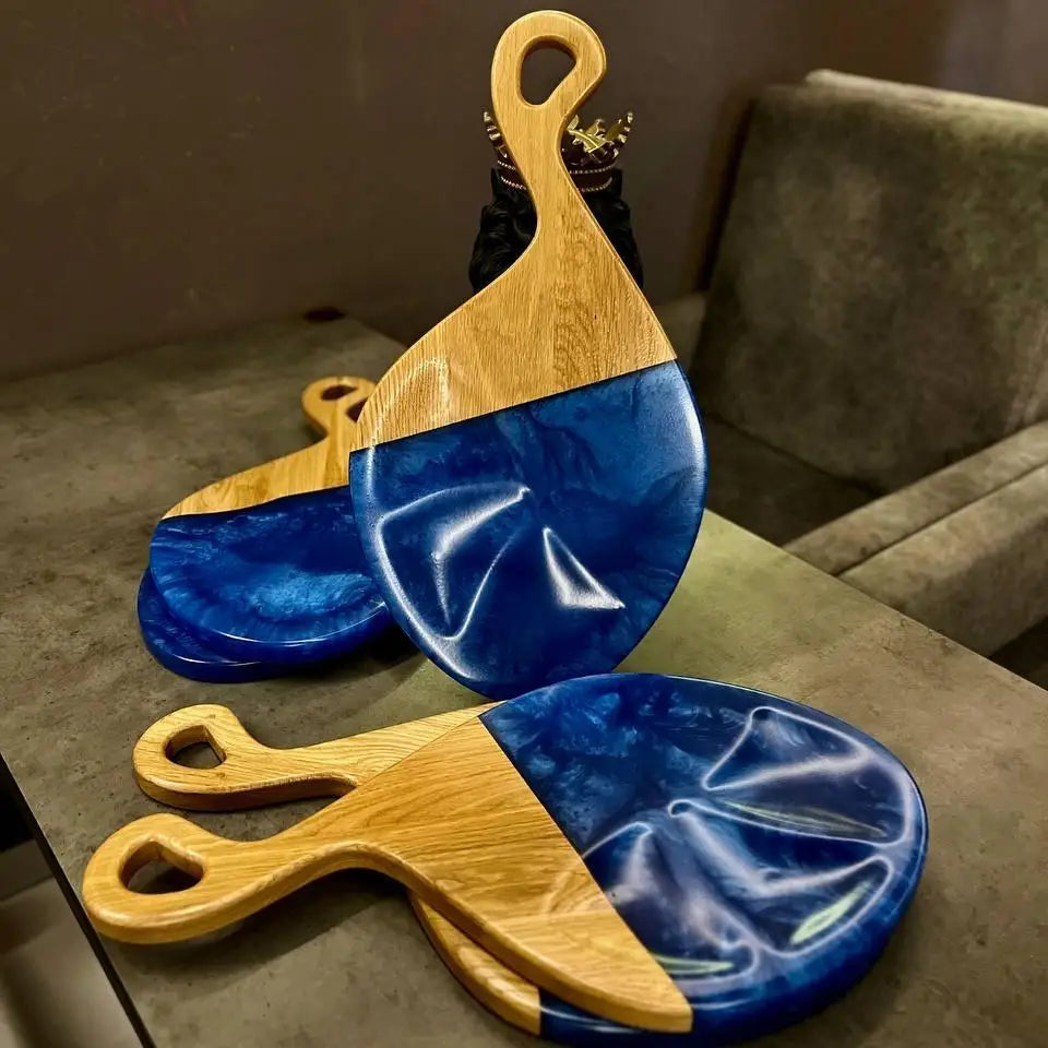 Handmade wooden cheese board with blue epoxy resin made from solid oak for serving cheese and wine