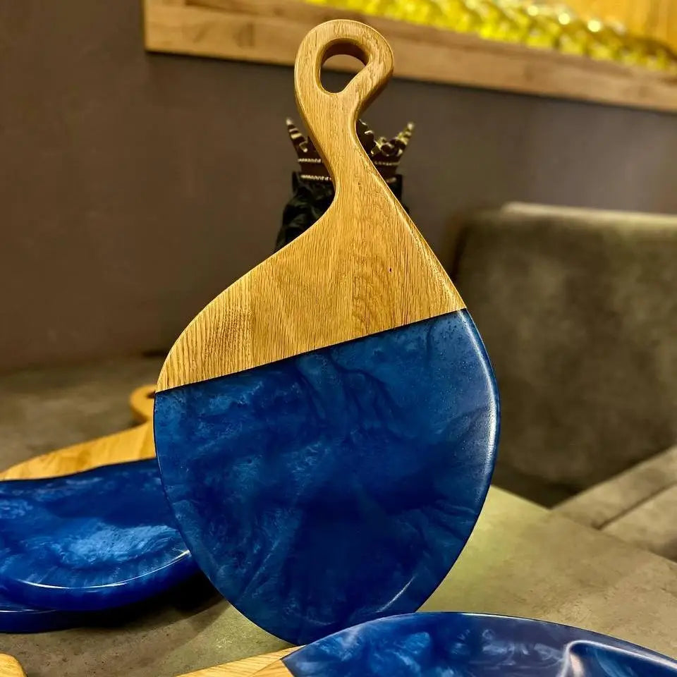 Oak charcuterie serving board with blue epoxy resin for cheese, appetizers and snacks