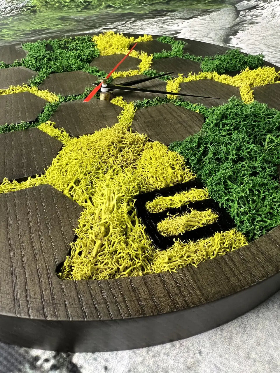 Wooden wall clocks decorated with different shades of green moss