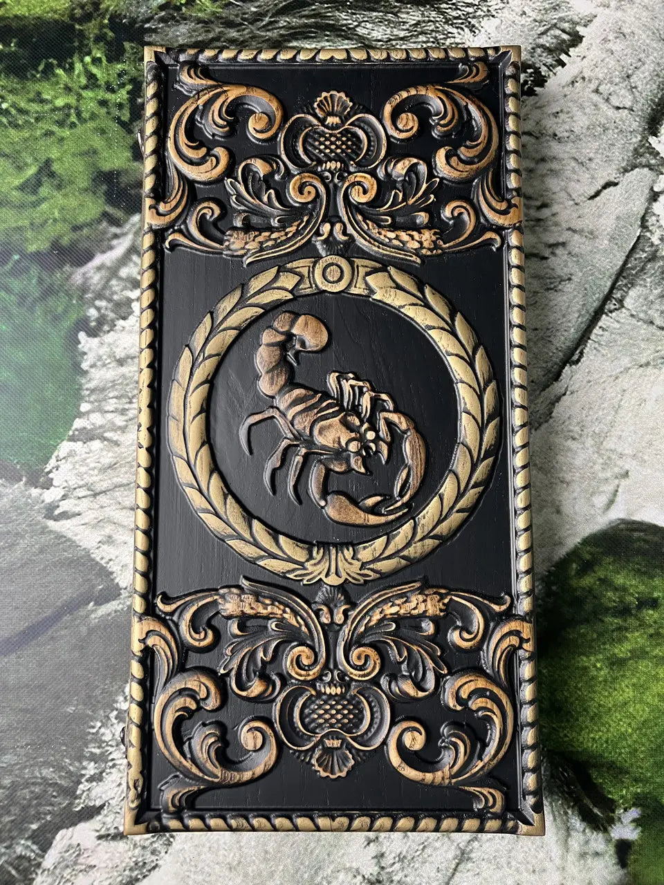 Close-up of Scorpio zodiac wooden backgammon board