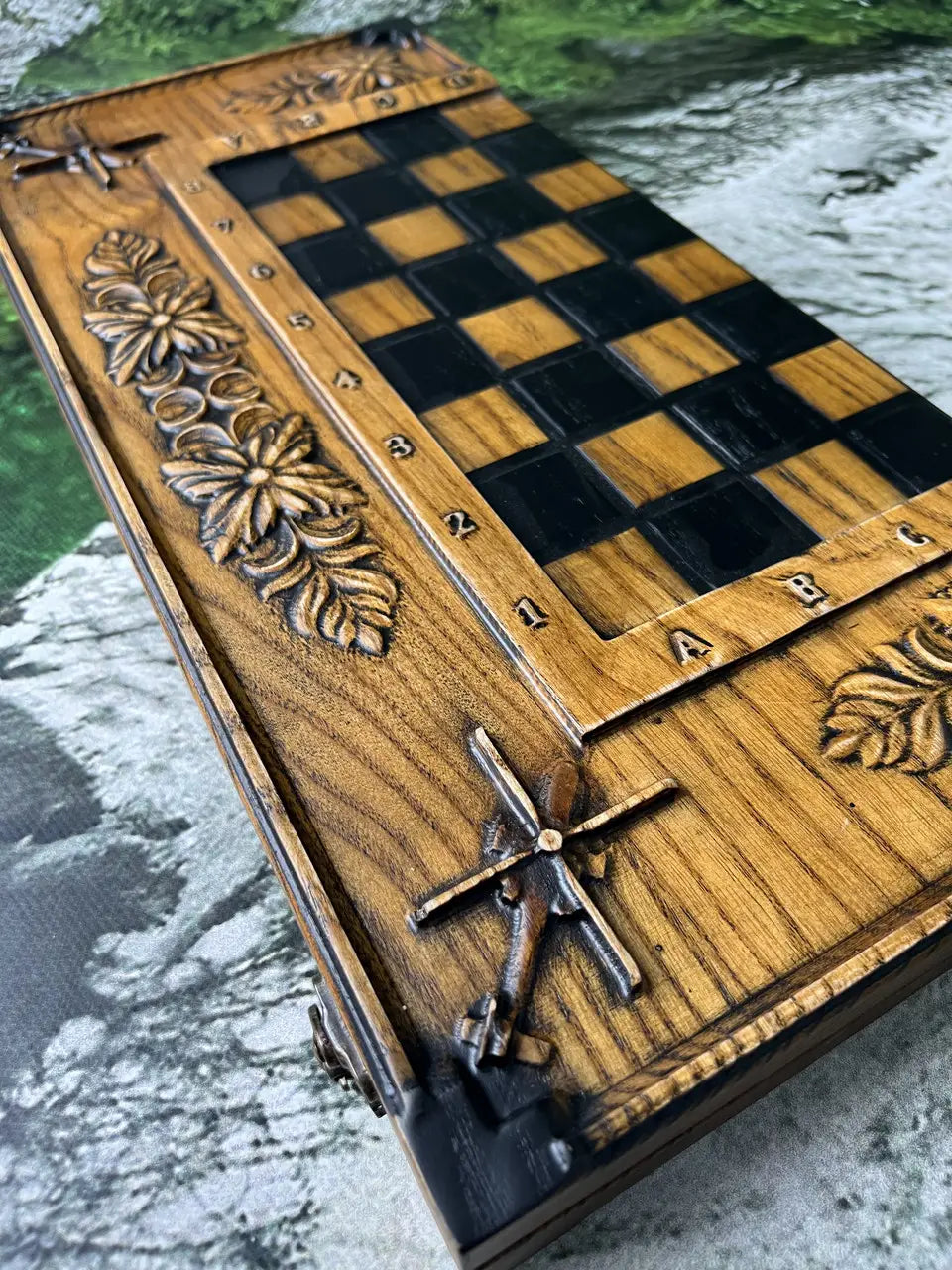 Close-up of carved ash wood chess board with dark and natural squares