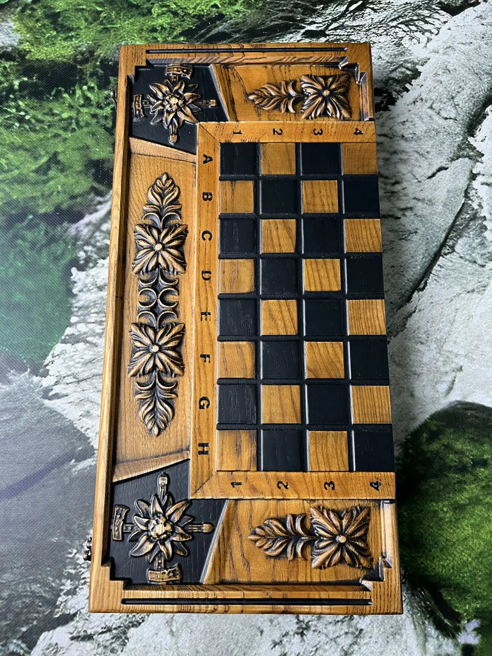 Wooden chessboard surface with engraved coordinates and dark contrasting squares