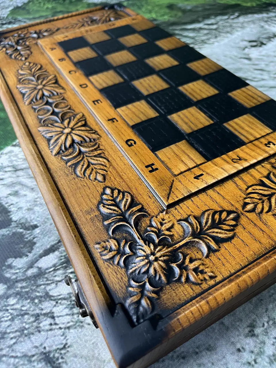 Wooden chessboard with deep carving and dark stained squares