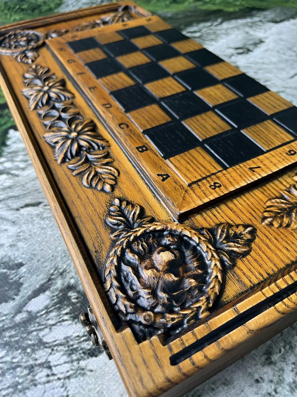 Close-up of hand carved lion ornament on wooden chess backgammon board, artisan woodworking detail