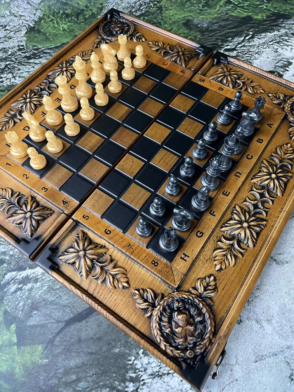 Luxury chess resin pieces in gold and black colors on wooden chessboard, royal style