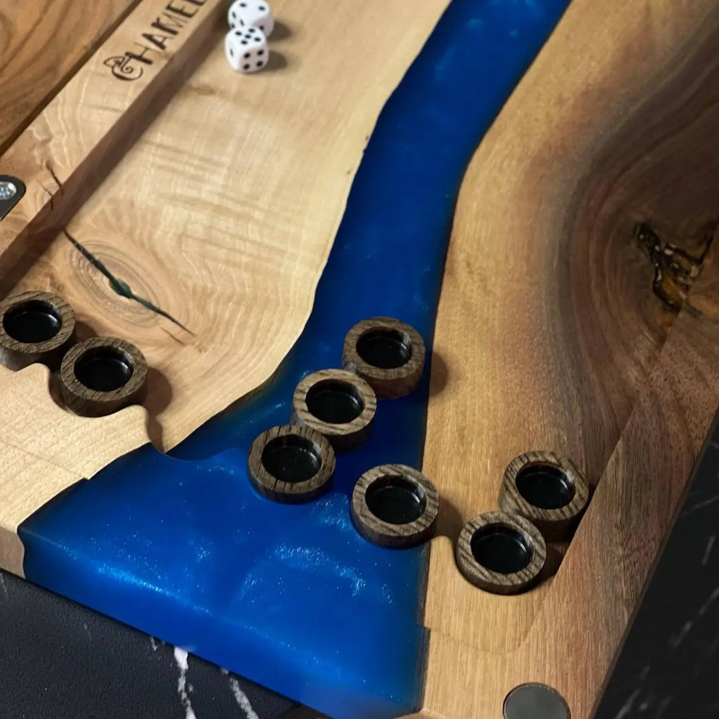 Wooden backgammon checkers on handcrafted board with cobalt blue epoxy resin