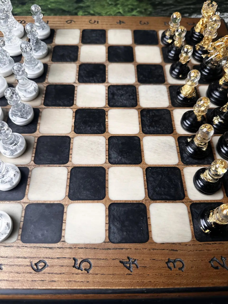 Close-up of chess board with epoxy resin black and white squares in natural ash wood