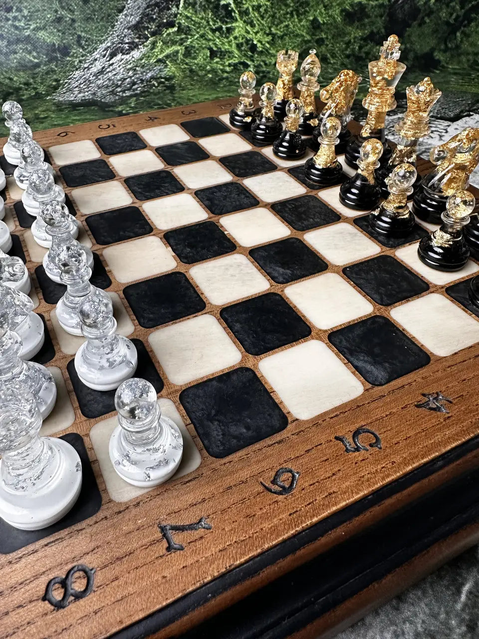 Luxury chess set with clear and gold resin chess pieces on wooden board