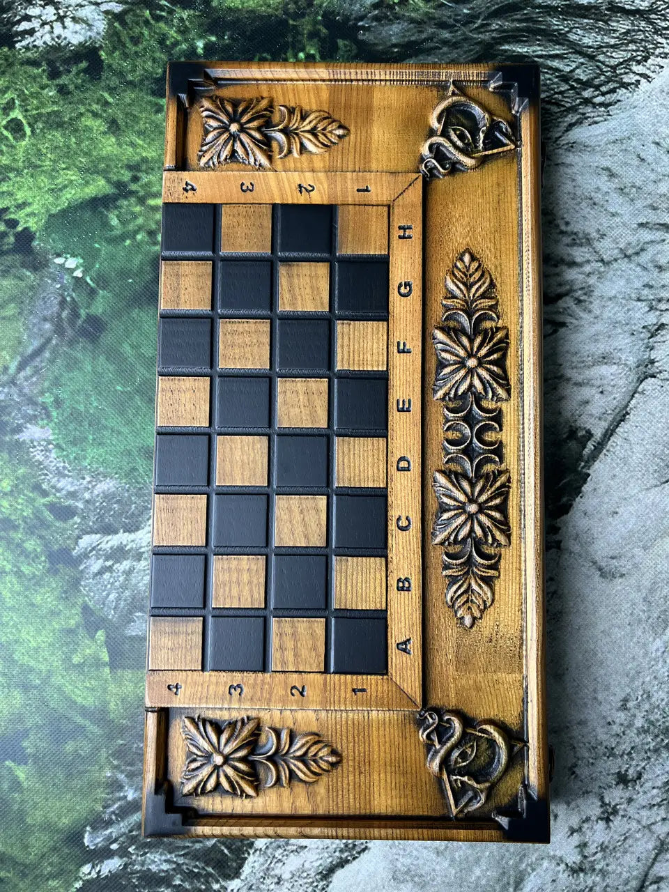 Detail of resin checkers and dice on carved ash wood backgammon board