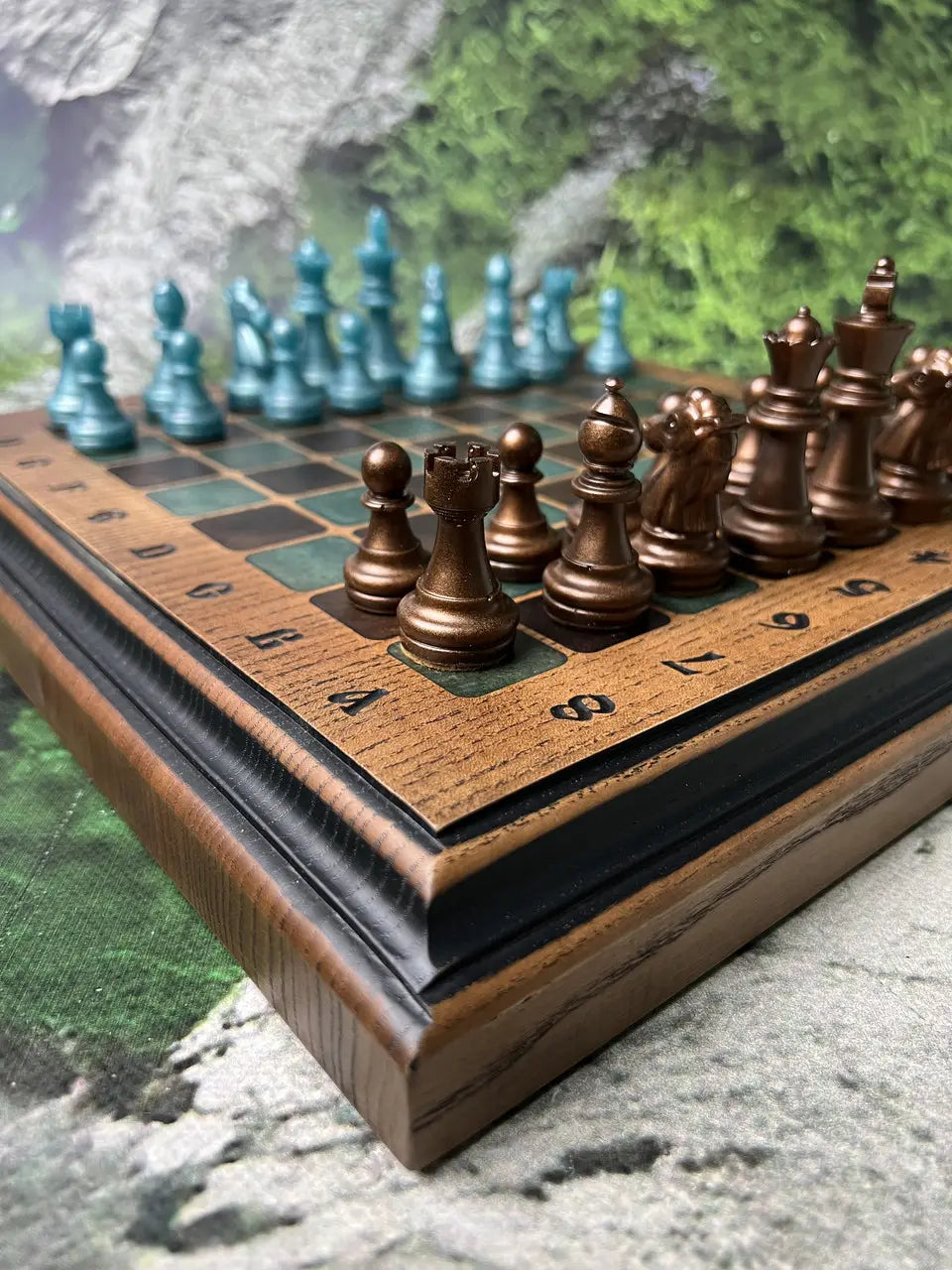 Premium wooden chess board with velvet bronze and teal resin chess pieces close-up view