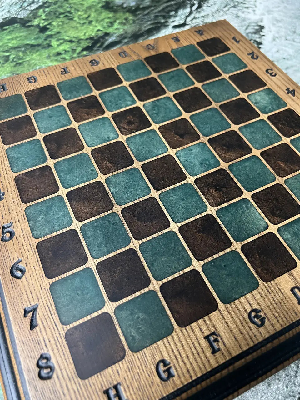 Handcrafted ash wood chess board with epoxy resin squares close-up