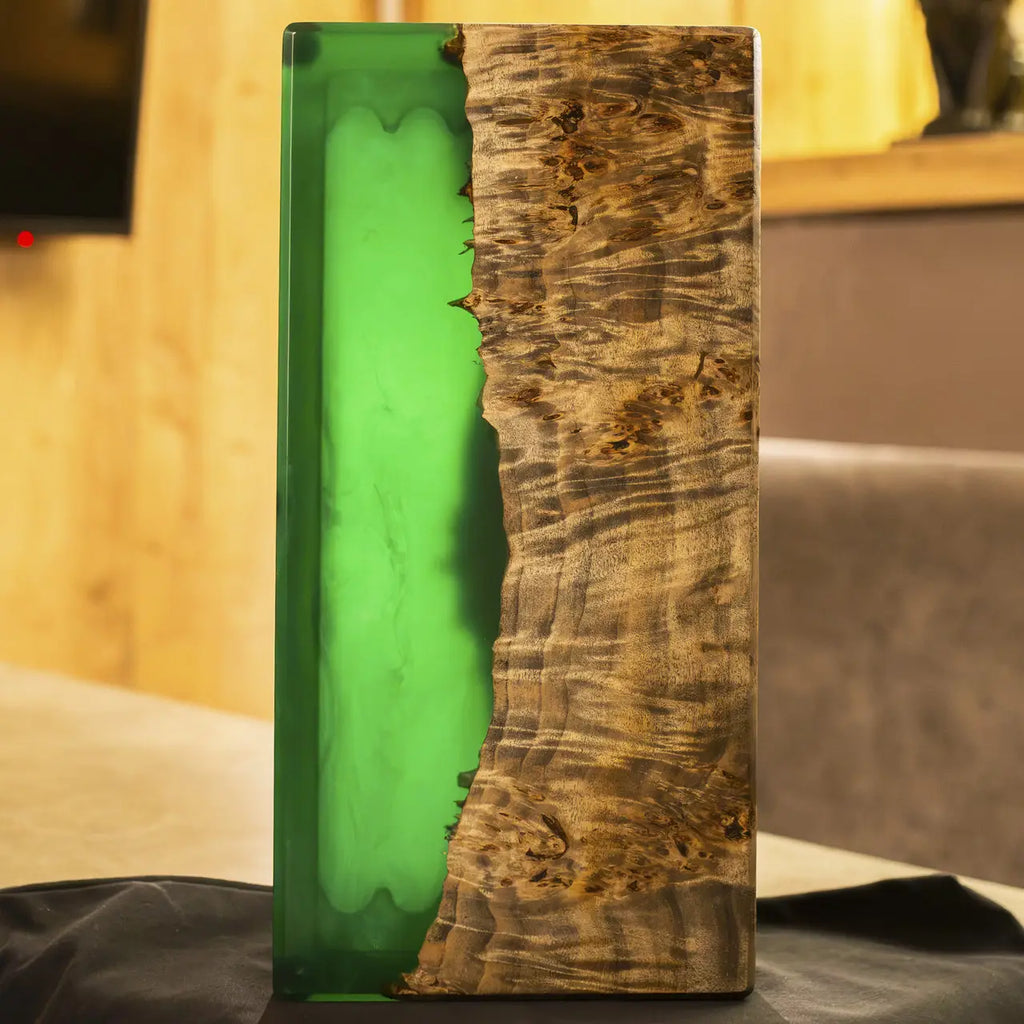 Natural wooden playing pieces on green epoxy backgammon board