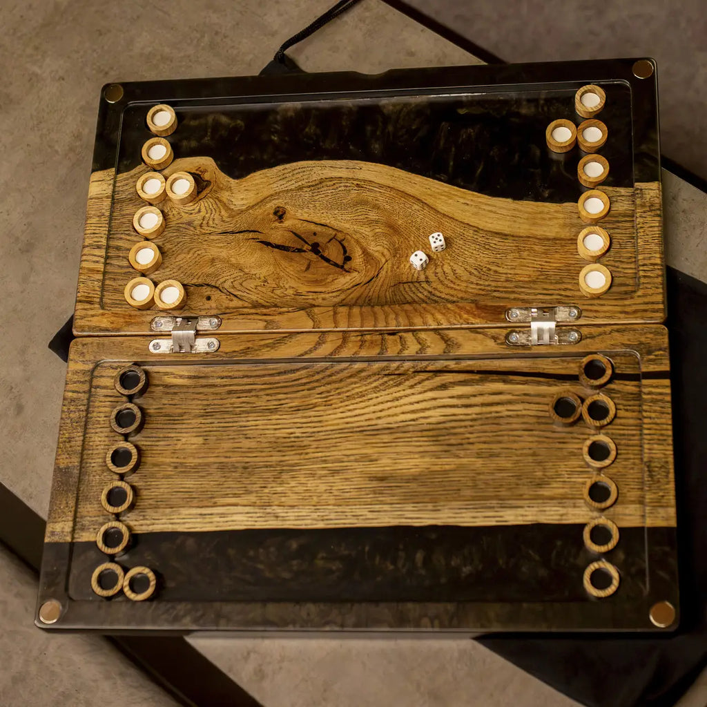 Top view of Noir luxury wooden backgammon board with checkers and dice