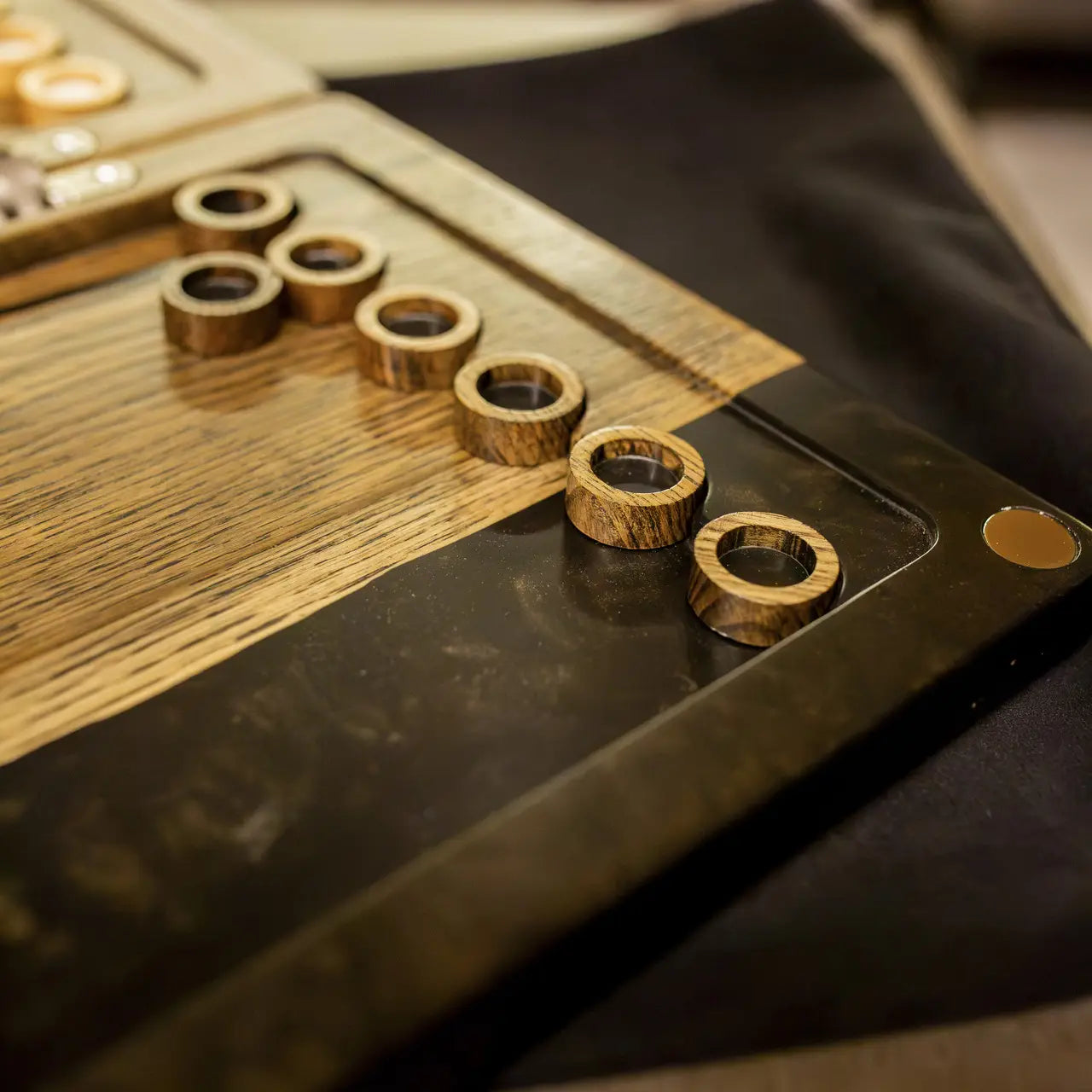 Folded Noir luxury backgammon board with natural wood grain and black resin