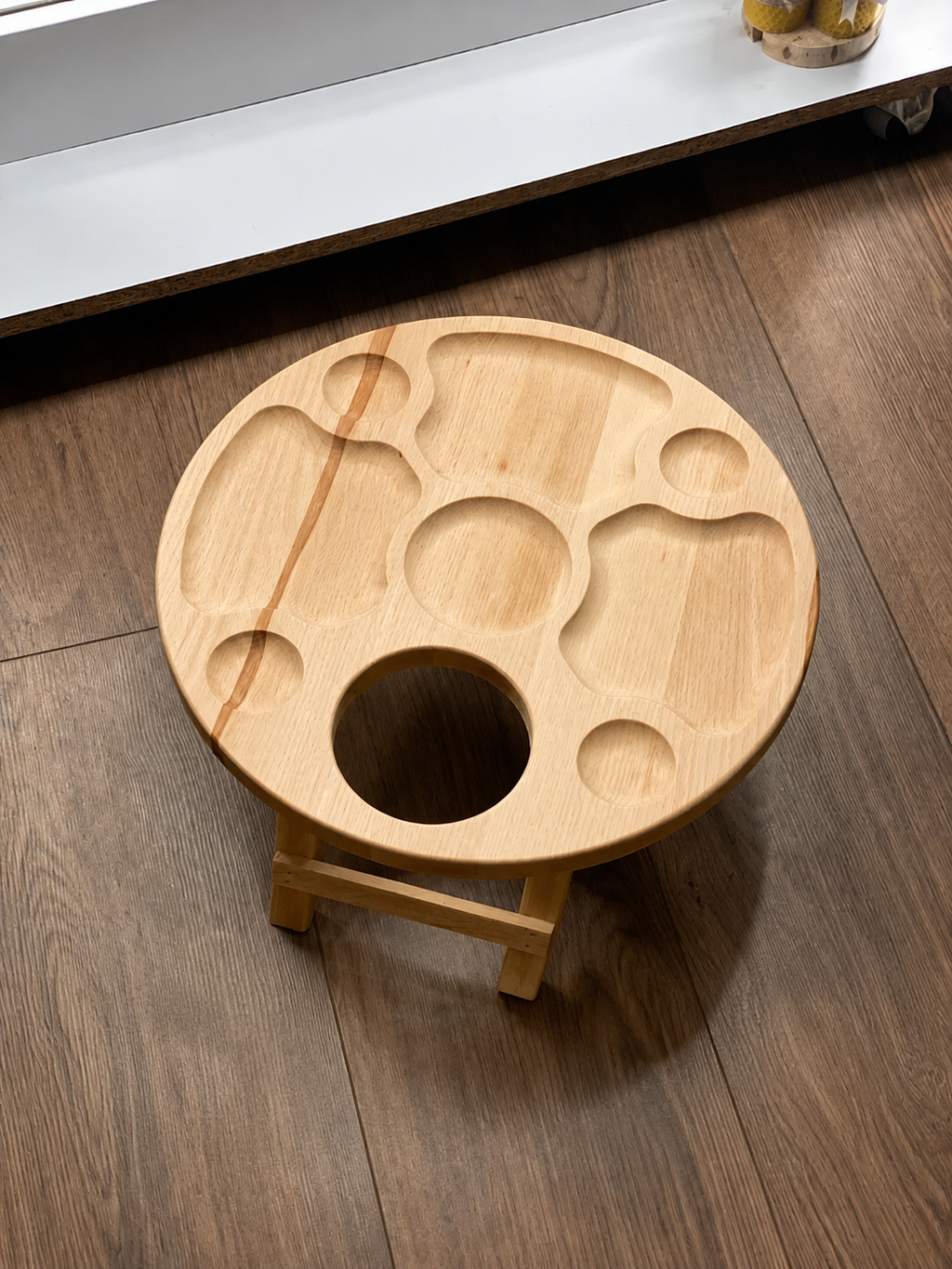 Round oak serving board with foldable legs for picnics and entertaining