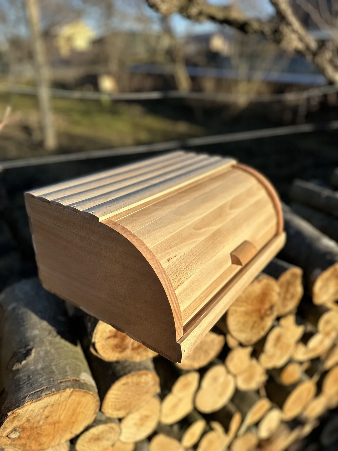 Wooden bread box with roll top lid and natural beech finish