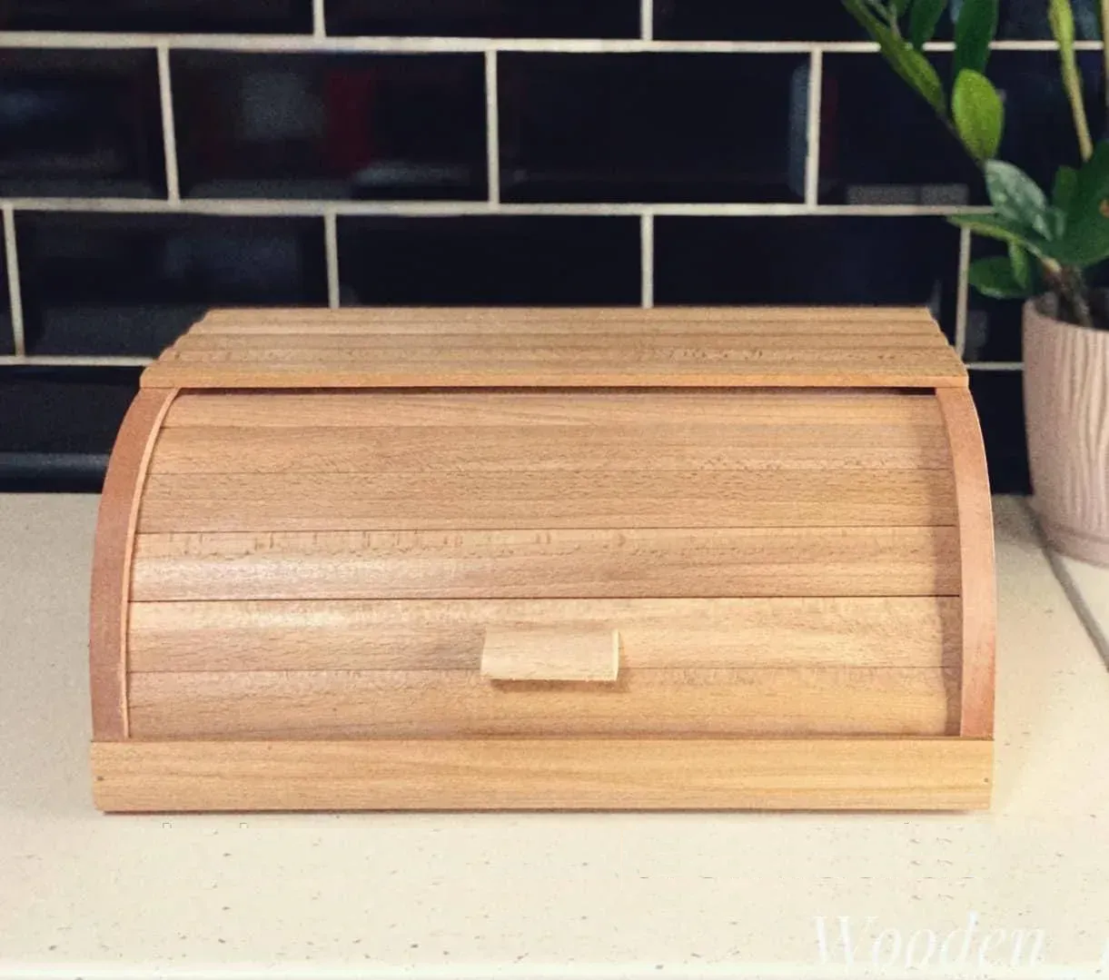 Eco wooden bread box handmade from natural beech wood on stacked firewood