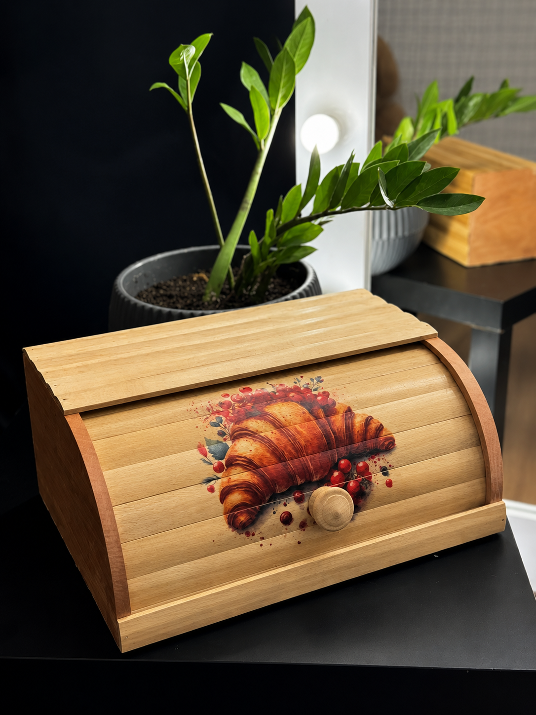 Wooden bread box featuring decorative croissant design for kitchen storage