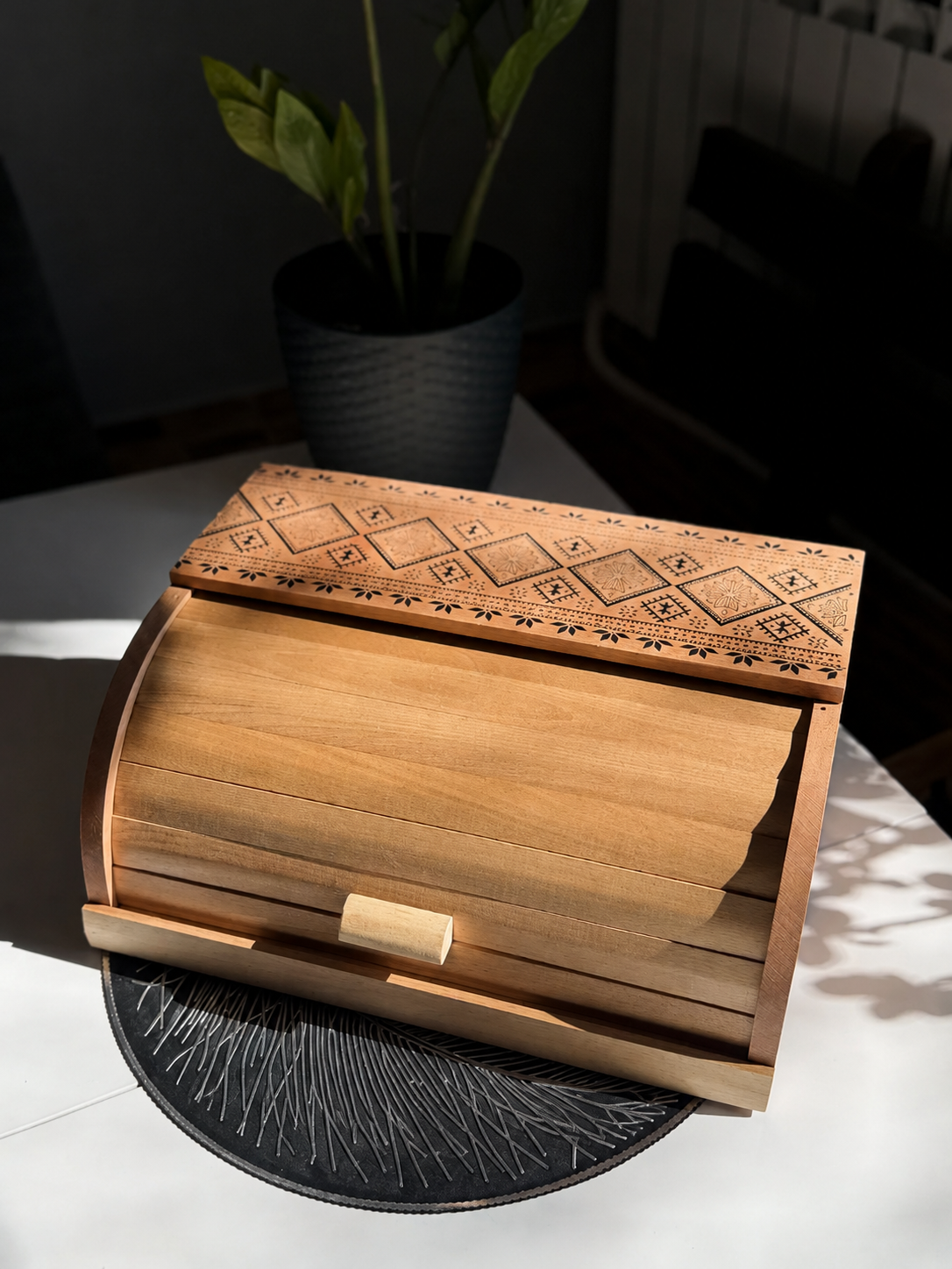 Handmade wooden bread bin with engraved pattern