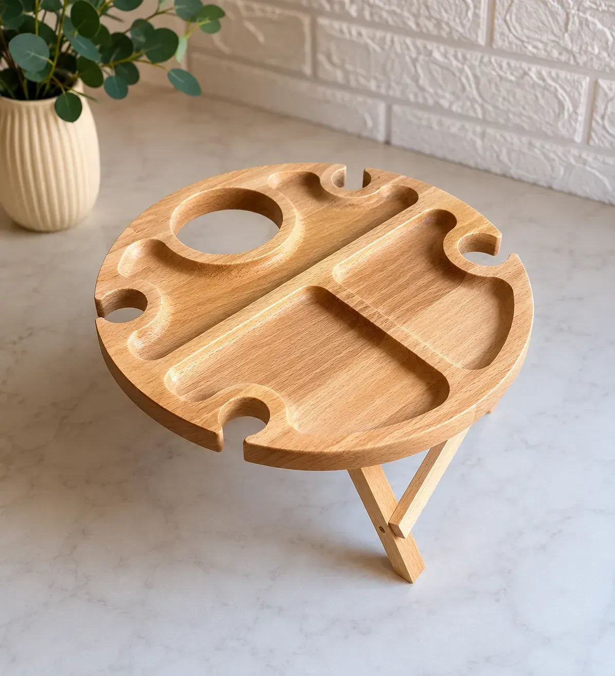 Round wooden wine and snack picnic table with holders for four wine glasses and a bottle