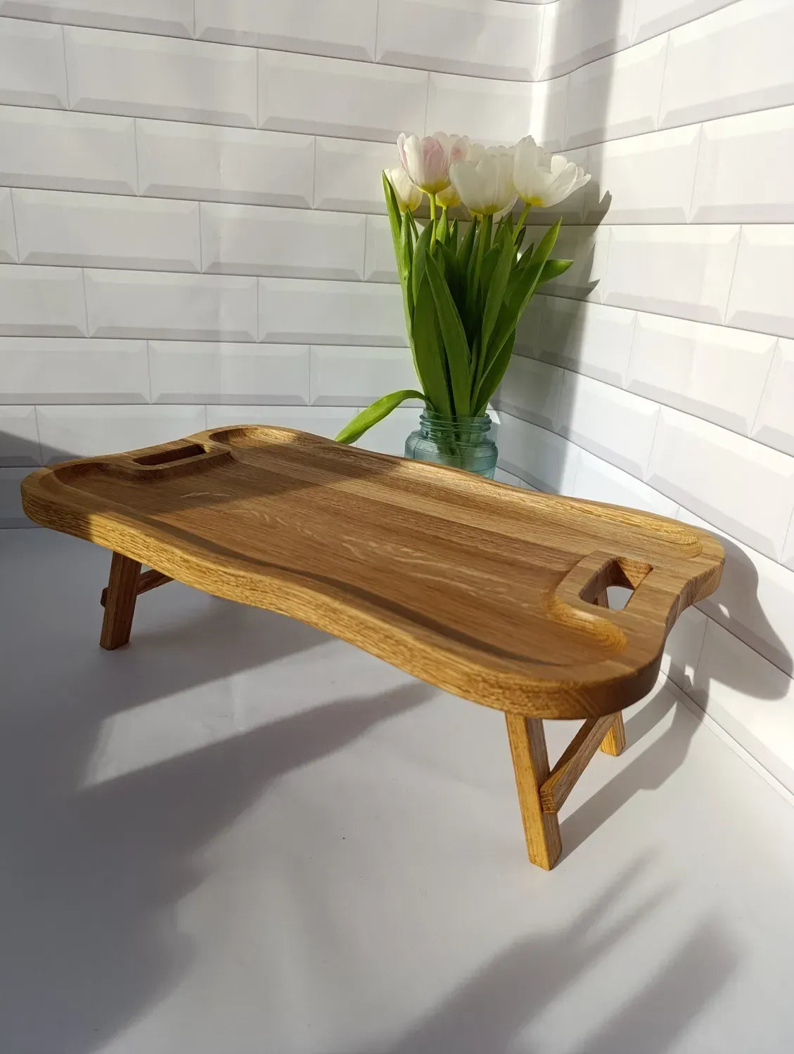 Angled view of a wooden lap desk with ergonomic shape and durable wooden support.