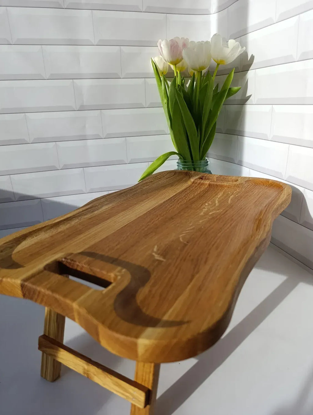Elegant wave-edge wooden serving tray table, ideal for breakfast in bed or laptop use.