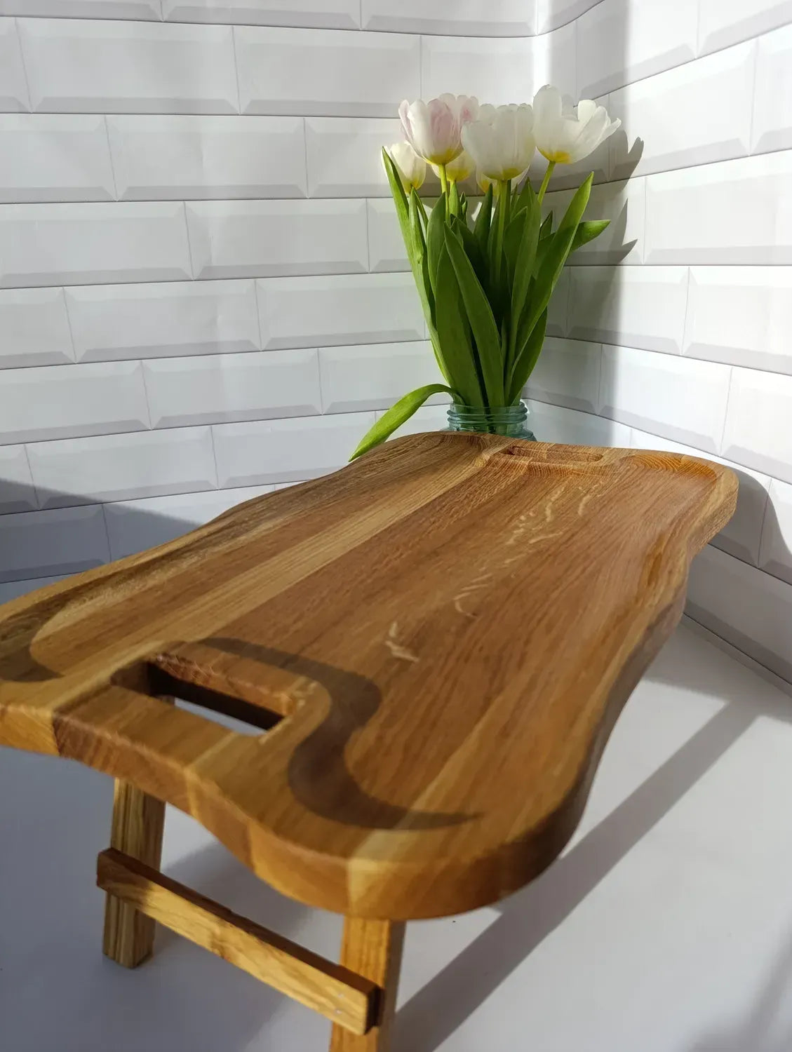 Elegant wave-edge wooden serving tray table, ideal for breakfast in bed or laptop use.