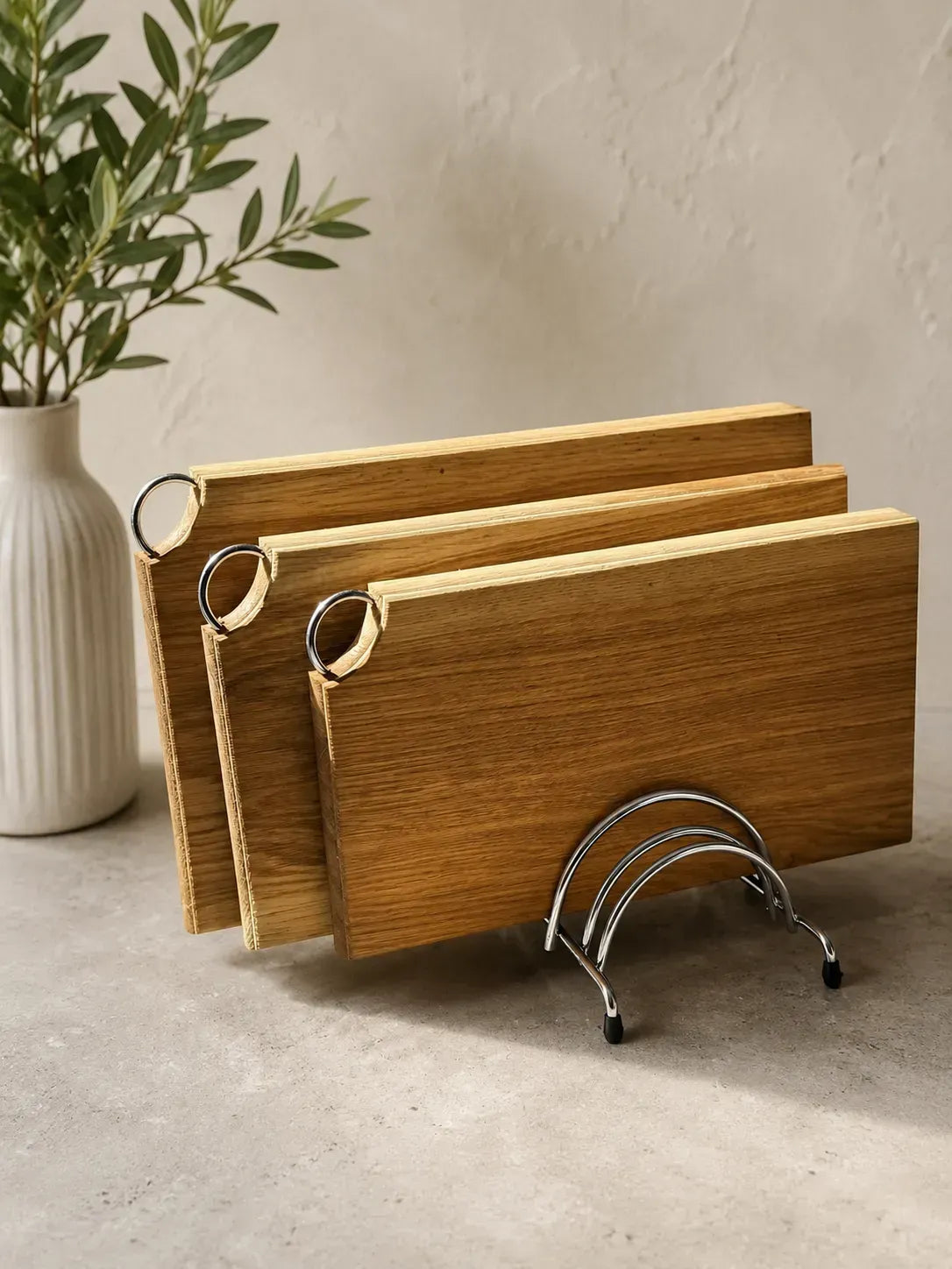 Handmade oak cutting board set with three wooden boards and metal storage stand