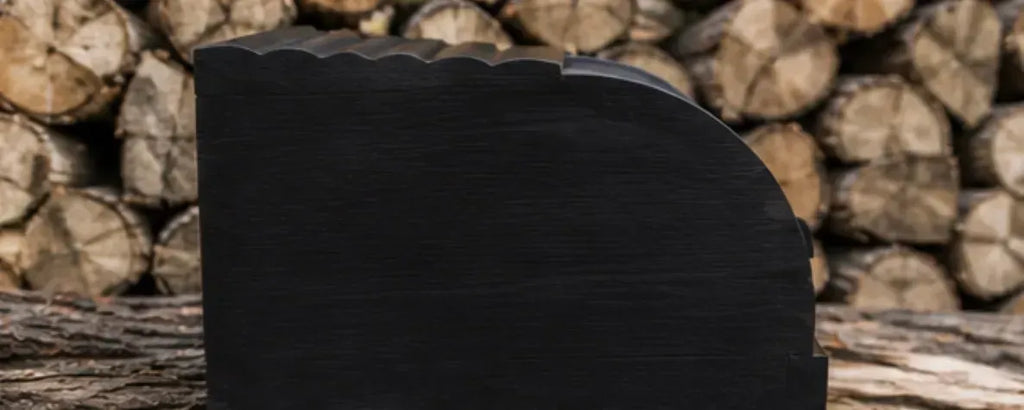 Elegant black wooden bread bin displayed on stacked firewood outdoors