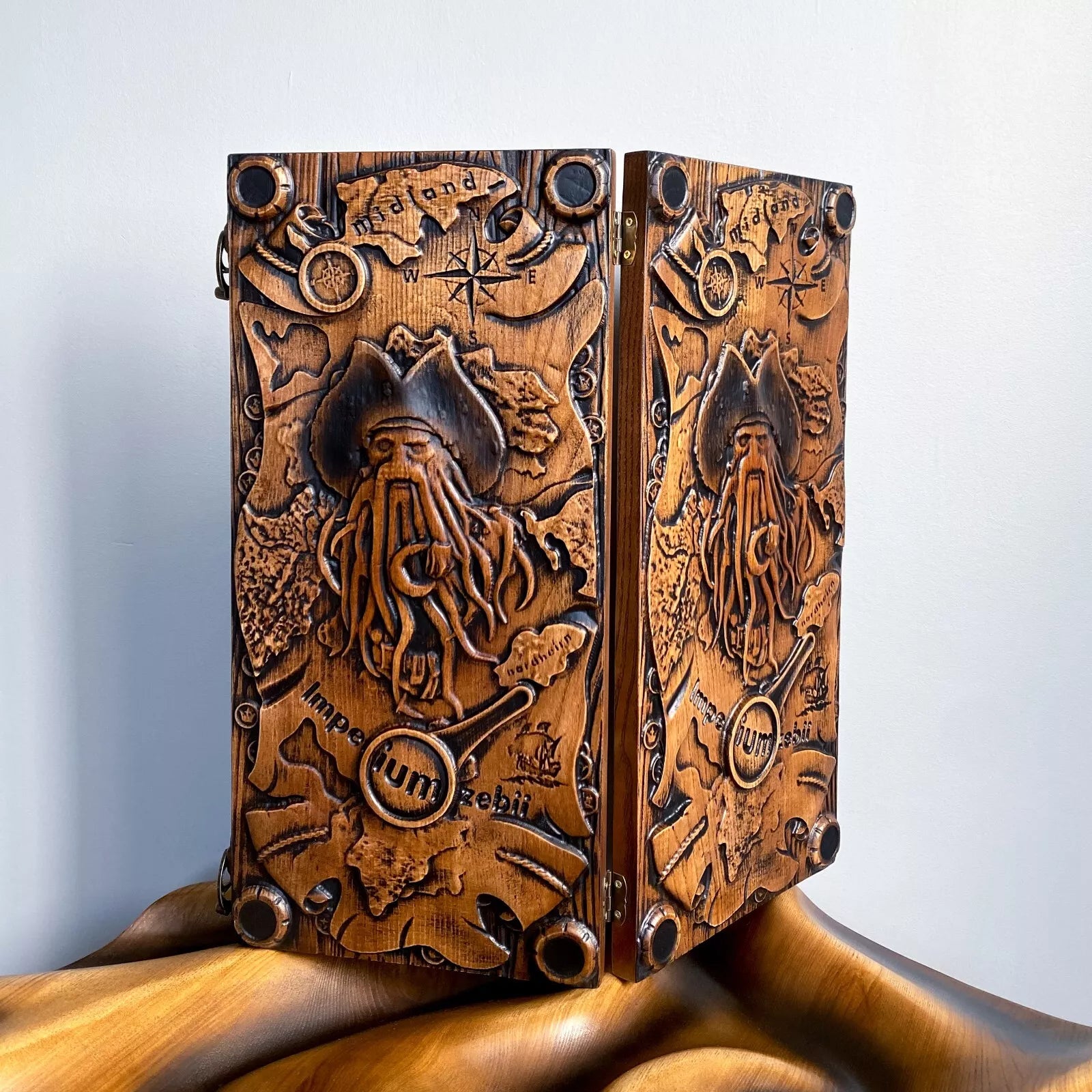 Handcrafted backgammon set with a detailed Davy Jones–style carving, nautical map, compass, and pirate motif.