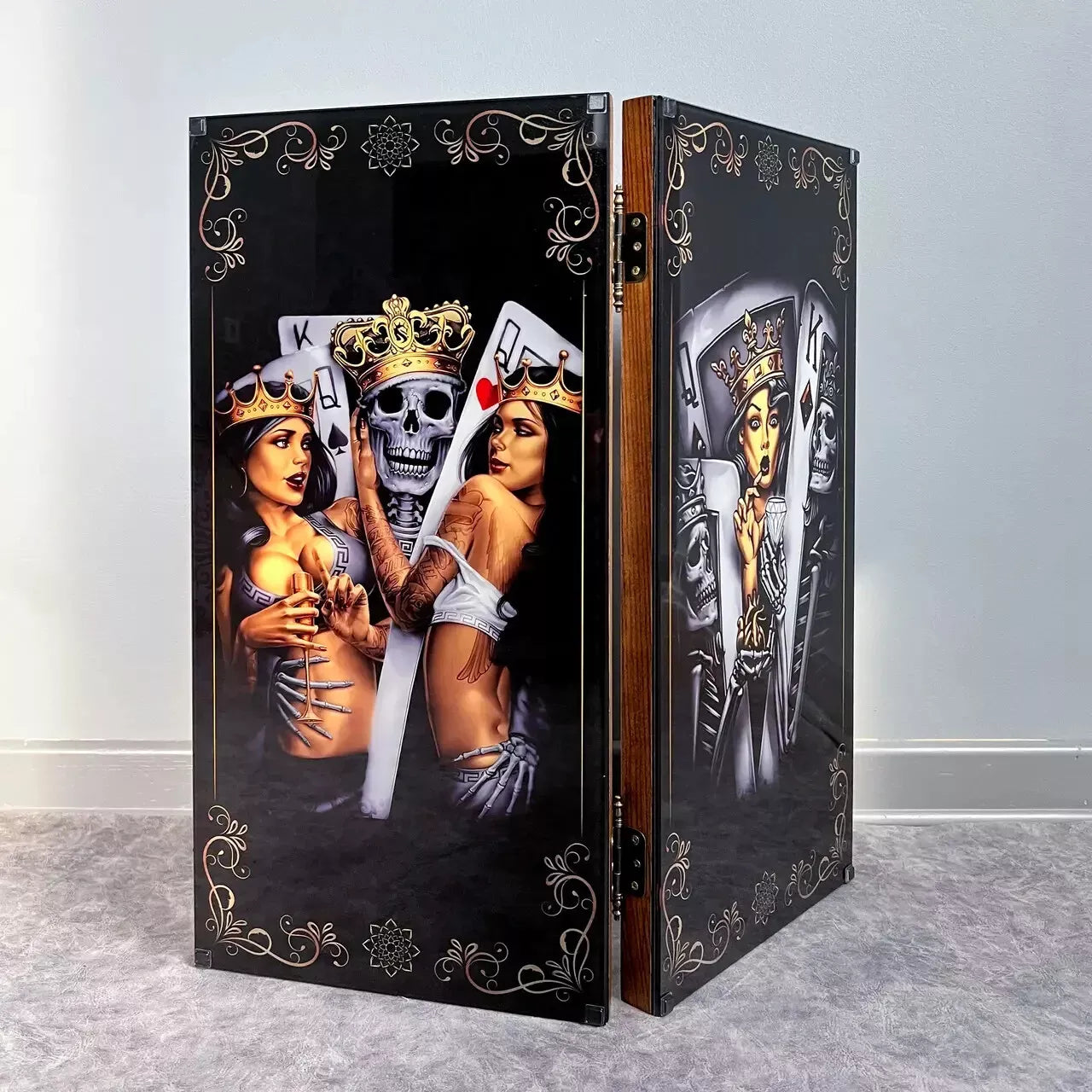 Luxury wooden backgammon set with black glass panels showing royal card characters, skulls, and ornate decorative patterns