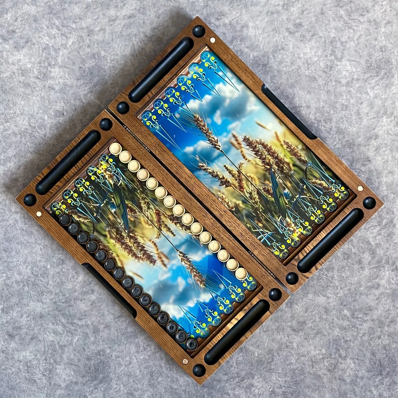 Open wooden backgammon board with wheat field artwork under glass, ash wood frame and playing pieces