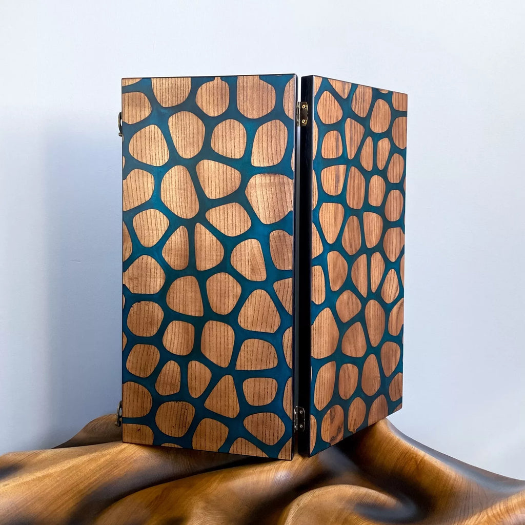 Closed backgammon case featuring a modern resin-inlaid design resembling organic stone or giraffe pattern.